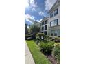 Attractive condo building showing balcony and manicured landscaping at 11446 Jasper Kay Terrace # 202, Windermere, FL 34786