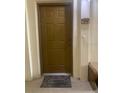 Apartment front door with a welcome mat outside, adjacent to a bench and the unit number at 11446 Jasper Kay Terrace # 202, Windermere, FL 34786
