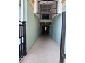 Inviting covered walkway with tiled floors and painted walls, providing access to the building's interior at 11446 Jasper Kay Terrace # 202, Windermere, FL 34786