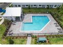 Aerial view of the community pool area, surrounded by lush landscaping and lounge chairs at 1533 Heritage Pl, Oviedo, FL 32765