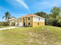 A charming two-story house featuring an attached two-car garage and an arched entryway at 2004 Prescott Blvd, Deltona, FL 32738