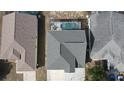 Aerial view of a well-maintained home featuring a backyard screened-in pool area at 339 Sigmund Loop, Davenport, FL 33837