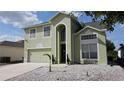 Charming two-story home with an arched entryway and manicured, low-maintenance landscaping at 339 Sigmund Loop, Davenport, FL 33837