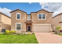 Charming two-story home with a paved driveway, a two-car garage and well maintained lawn at 8828 Bengal Ct, Kissimmee, FL 34747