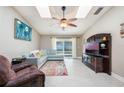 Cozy living room with lots of natural light, a modern ceiling fan, and tile flooring at 1052 Dees Dr, Oviedo, FL 32765
