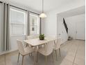 Bright dining room features a modern table with six chairs beneath a pendant light fixture at 14154 Shocklach Dr, Winter Garden, FL 34787
