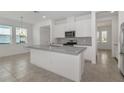 Bright kitchen featuring stainless appliances, granite countertops, and a large island with a breakfast bar at 14154 Shocklach Dr, Winter Garden, FL 34787