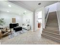 Open-concept living room with tile flooring, and staircase at 2240 Osprey Ave, Orlando, FL 32814