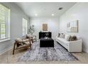 Bright living room with neutral tones, large windows, and minimalist decor at 2240 Osprey Ave, Orlando, FL 32814