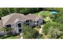 Aerial view of a townhouse complex with a playground and green spaces at 6506 Swissco Dr # 1317, Orlando, FL 32822