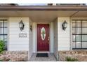 Elegant front entrance with a red door, decorative sidelights, stylish lighting fixtures and charming details at 1017 American Beauty St, Orlando, FL 32818
