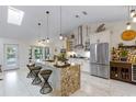 Bright, updated kitchen featuring a large island, stainless steel appliances, and sleek white cabinetry at 1017 American Beauty St, Orlando, FL 32818