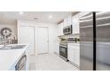 Bright kitchen featuring white cabinets, stainless steel appliances, and a functional island at 114 Tulip Ln, Poinciana, FL 34759