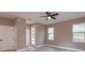 Well-lit bedroom with ceiling fan, closet, and a window with outside views at 1340 Crystal Lake E Ave, Orlando, FL 32806