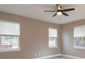 Comfortable bedroom with two windows and a ceiling fan at 1340 Crystal Lake E Ave, Orlando, FL 32806