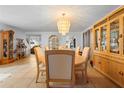 Open dining room with tiled floor, chandelier, wood furniture and bright light at 1430 Clarks Summit Ct, Orlando, FL 32828