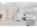 Open-concept with tile floors and living room featuring a modern staircase and bright design at 1675 Amsel Falls Park Ter, Winter Garden, FL 34787