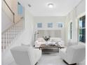 Bright Living Room with white furniture, tile floors, staircase, and modern design at 1675 Amsel Falls Park Ter, Winter Garden, FL 34787