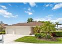 Single story home with a well-manicured lawn and 2 car garage showcasing its curb appeal at 1842 Turnbull Lakes Dr, New Smyrna Beach, FL 32168