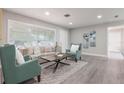 Bright living room featuring luxury flooring, a large window and tastefully curated furniture at 2113 Winnetka Ct, Orlando, FL 32818