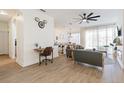 Open concept living room with modern furnishings, a ceiling fan, and hardwood flooring throughout at 217 Herring St, Davenport, FL 33897
