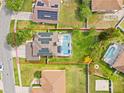 Aerial view of property lines, home with a pool and solar panels in a well-maintained, lush green neighborhood at 239 Longhirst Loop, Ocoee, FL 34761