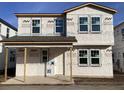 New home construction showing the front of the house with windows and covered porch at 2395 Zuni Road, St Cloud, FL 34771