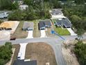 An aerial view of a home with a driveway on a corner lot surrounded by lush greenery at 2644 Sw 162 Nd Street Rd, Ocala, FL 34473