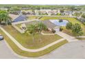 An aerial perspective of a residence featuring mature trees, manicured landscaping, and a serene pond at 2844 Eagle Lake Dr, Orlando, FL 32837