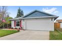 Charming single-story home with a two-car garage, red shutters, and well-manicured front lawn at 3192 Running Deer Path, Kissimmee, FL 34746