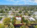 Expansive aerial view of the property surrounded by lush greenery and waterway in a beautiful neighborhood at 3204 Tradewinds Trl, Orlando, FL 32805