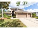 Charming two-story home with a three car garage and a well maintained front yard at 341 Kirkhill St, Ocoee, FL 34761