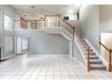 Spacious living room featuring high ceilings, a staircase to the second floor, and tile flooring at 341 Kirkhill St, Ocoee, FL 34761