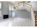 Spacious living room featuring high ceilings, a fireplace, and a staircase to the second floor at 341 Kirkhill St, Ocoee, FL 34761