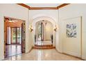 Grand foyer featuring marble floors, arched doorways, decorative sconces, and views through a decorative arched doorway at 3412 Lilas Ct, Windermere, FL 34786