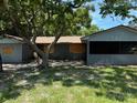 Exterior shot of a single-story home with boarded windows and an attached garage at 4302 Seybold Ave, Orlando, FL 32808
