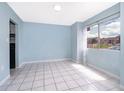 Cozy living room with white ceramic tile and a window at 5060 Downing St # 6, Orlando, FL 32839