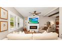 Cozy living room featuring a brick fireplace, plantation shutters, and stylish furnishings for comfortable living at 532 Darcey Dr, Winter Park, FL 32792