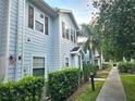 Charming townhome with light blue siding, brown shutters, and well-maintained landscaping at 5354 Diplomat Ct # 105, Kissimmee, FL 34746