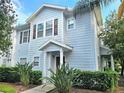 Beautiful townhome with light blue siding, brown shutters, and lush green landscaping at 5354 Diplomat Ct # 105, Kissimmee, FL 34746