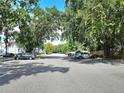 Community street view with lush green trees, street parking, and charming neighborhood setting at 5354 Diplomat Ct # 105, Kissimmee, FL 34746