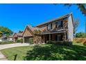 Spacious two-story brick home with a lush green lawn and mature trees at 5388 Birchbend Loop, Oviedo, FL 32765