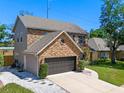 Beautiful brick home featuring a two-car garage and well-maintained landscaping at 5388 Birchbend Loop, Oviedo, FL 32765
