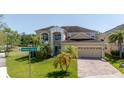 Inviting two-story home with a well-manicured lawn and a two-car garage, perfect for Gathering living at 5803 Cheshire Cove Ter, Orlando, FL 32829