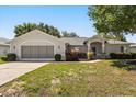 Charming single-story home with manicured landscaping and a two-car garage at 5962 Sw 98Th Street Rd, Ocala, FL 34476