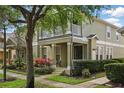 Charming townhome showcasing a welcoming front porch and upper-level balcony at 7130 Forty Banks Rd, Harmony, FL 34773