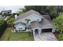 Stunning lake view home with a pristine lawn, two-car garage, and beautiful landscaping at 8616 Port Said St, Orlando, FL 32817