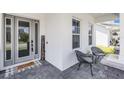 Inviting front porch with decorative welcome sign, comfortable seating, and stylish gray brick flooring at 9250 Neher St, Orlando, FL 32827