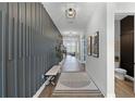 Modern hallway showcasing textured wall accents, recessed lighting, and stylish hardwood flooring at 9250 Neher St, Orlando, FL 32827
