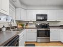 Efficient kitchen with white cabinets, neutral countertops and stainless steel appliances at 940 Douglas Ave # 118, Altamonte Springs, FL 32714